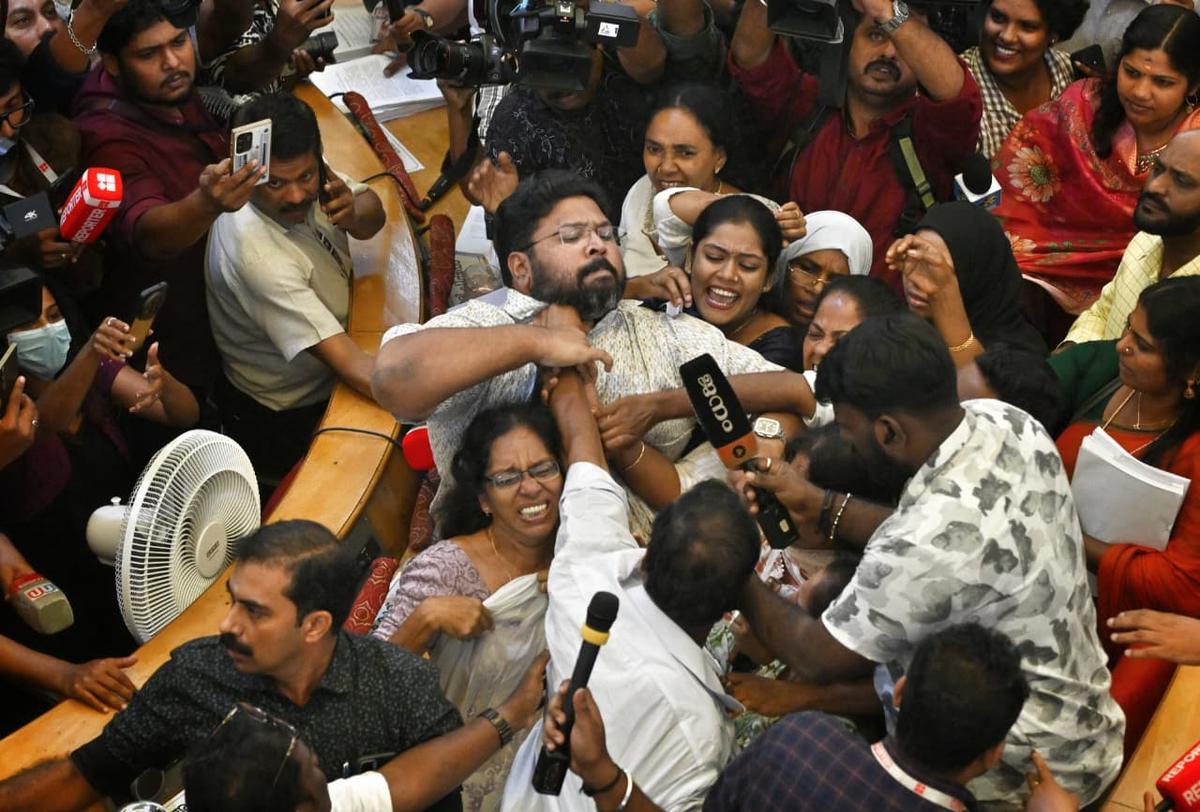 BJP councillor Chempazhanthy Udayan (back to the camera) attacks UDF councillor K.S. Sabarinathan (centre) as UDF councillors continued to protest after the council meeting concluded in Thiruvananthapuram Corporation on Monday. BJP and UDF councillors clashed following this.